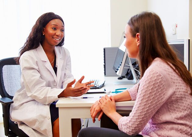 Patient Having Consultation With Female Doctor In Office