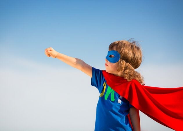 Child in superhero cape and mask