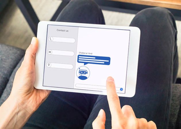 Person on tablet using chatbot on website