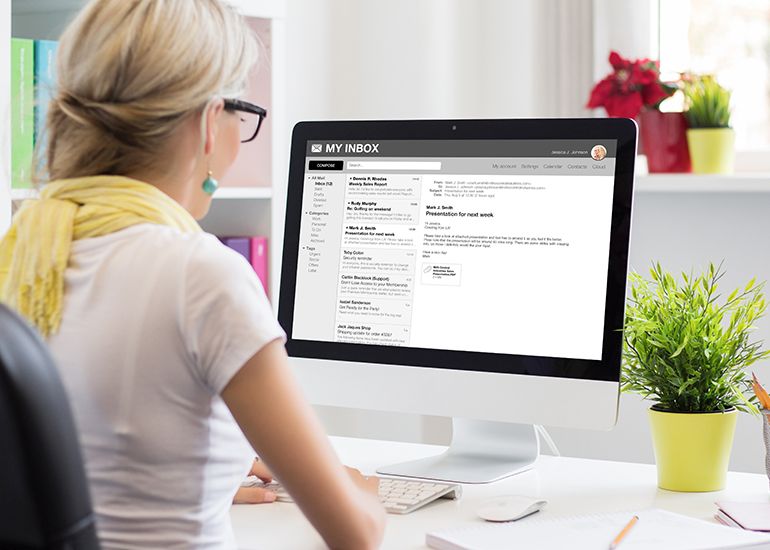 Woman checking emails on laptop