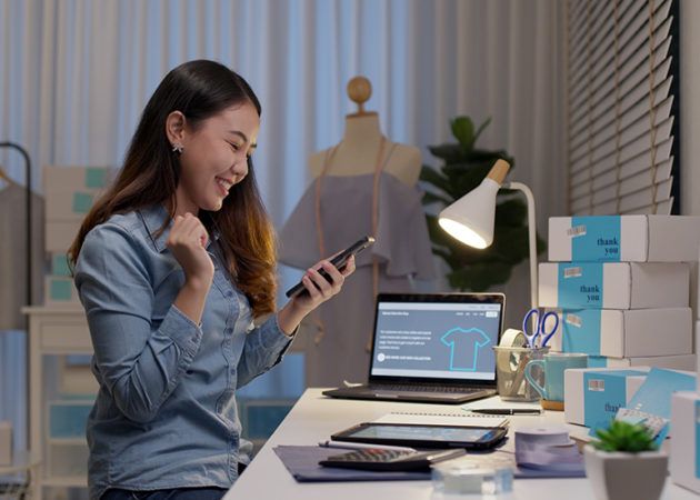 Woman using digital evices to check stock orders