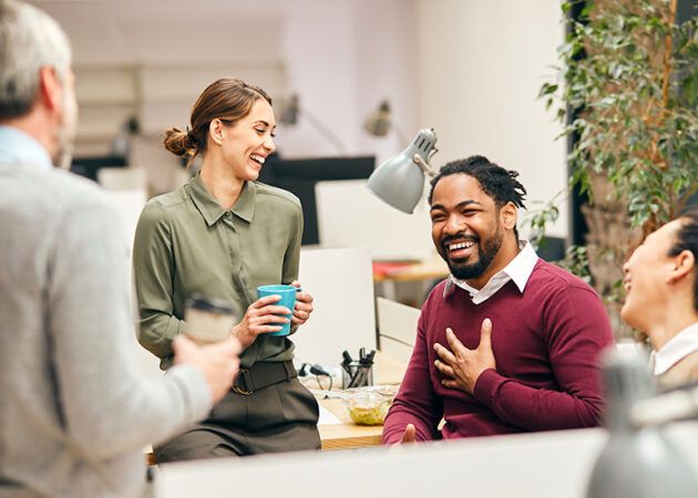 happy team relaxing in office on a break