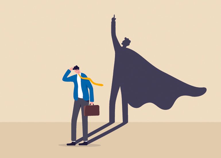 Cartoon of businessman looking doubtful while his shadow wears a superhero cape