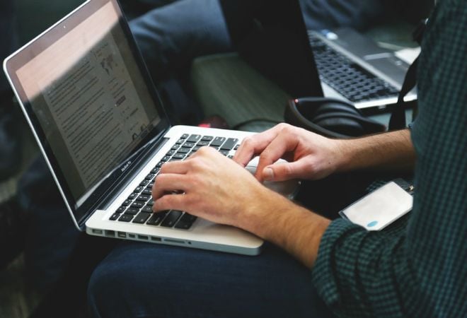 writing blog with laptop in lap