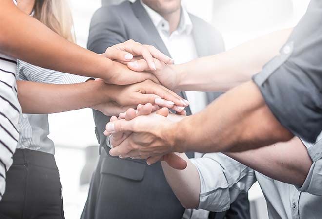 team with all hands in teamwork