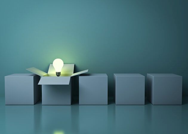 Light bulb rising out of an open cardboard box