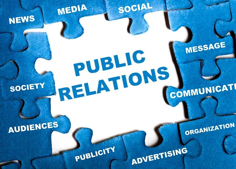 Puzzle with main piece showing 'public relations'