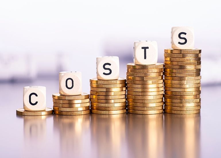 Piles of coins rising in height with the words 'costs' in Boggle cubes