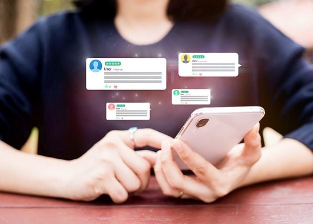 Woman checking phone for social media comments
