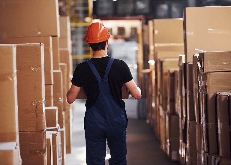 Storeman walking through warehouse