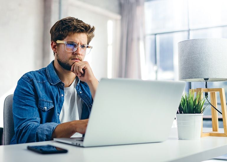 Worried man using computer