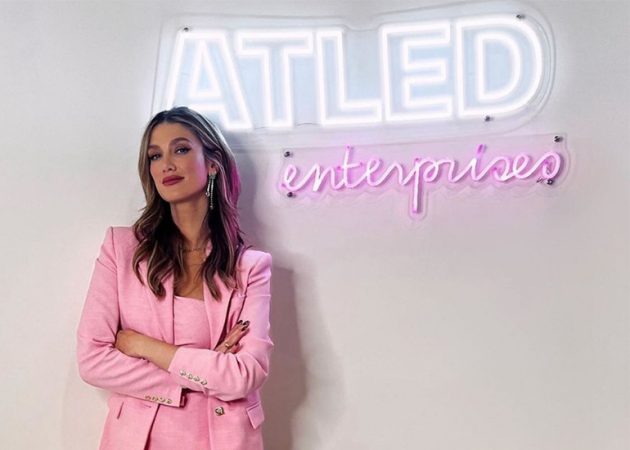 Delta Goodrem in front of her signage