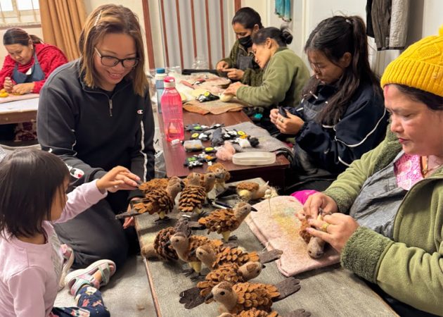 Nepalese artisans work on puppet creations
