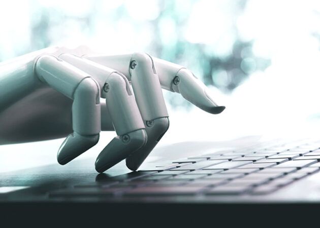 Robot hand on keyboard