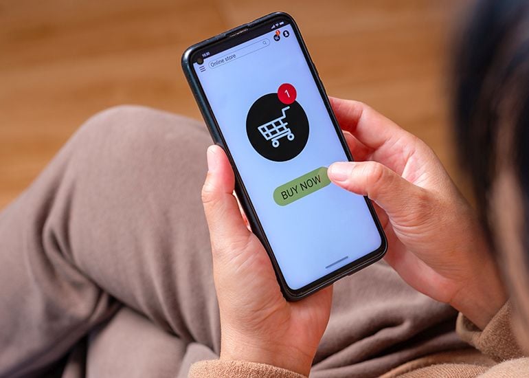 oman clicking buy now button on phone