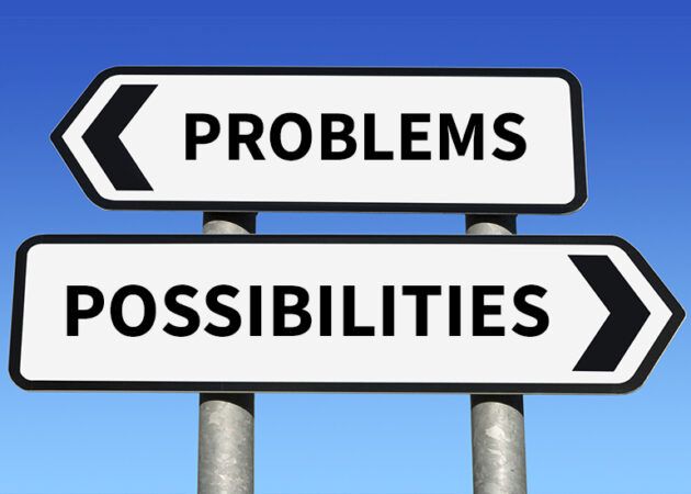 Street or road sign with the words 'problems' and 'possibilities'