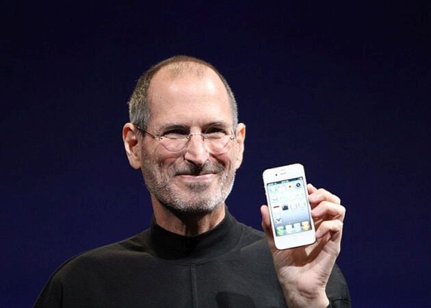Steve Jobs holding Apple iPhone