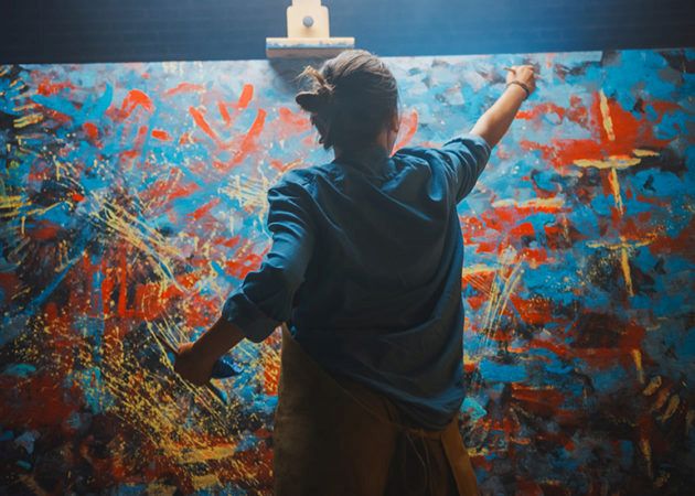 female artist painting on canvas