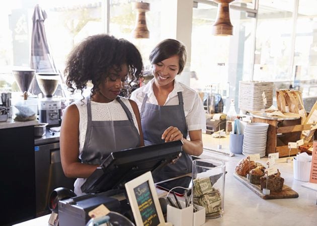 Cafe owner training new employee