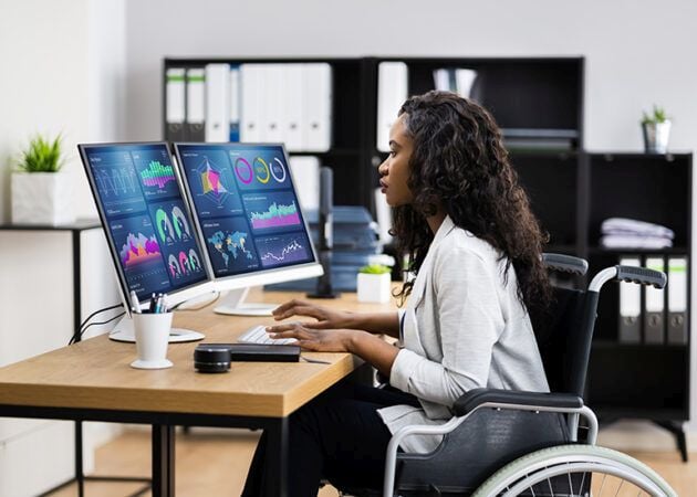 Woman in wheelchair working at desk