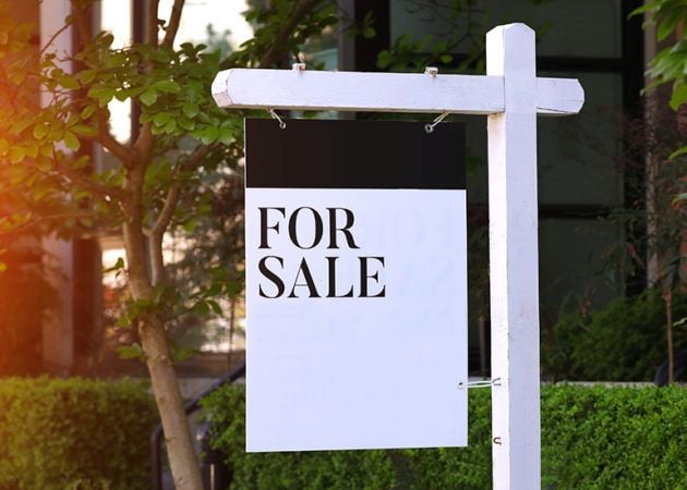 FOR SALE sign in front of office block