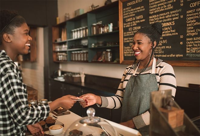 happy customer paying with card at counter