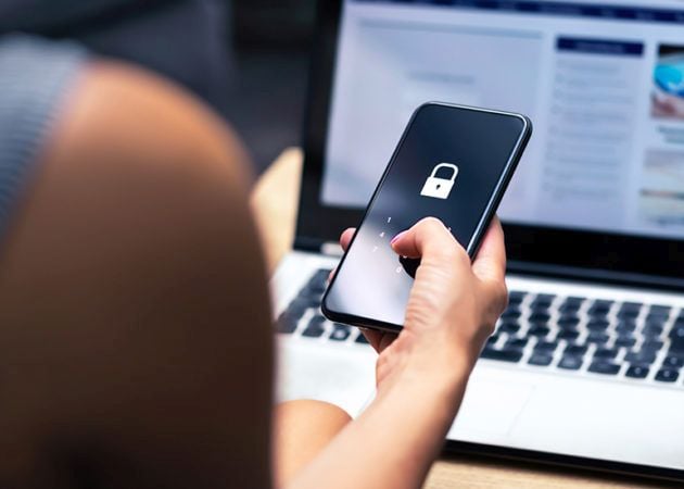 woman logging into phone with PIN number