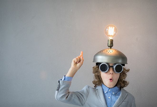 Young boy wearing helmet with lightbulb on top