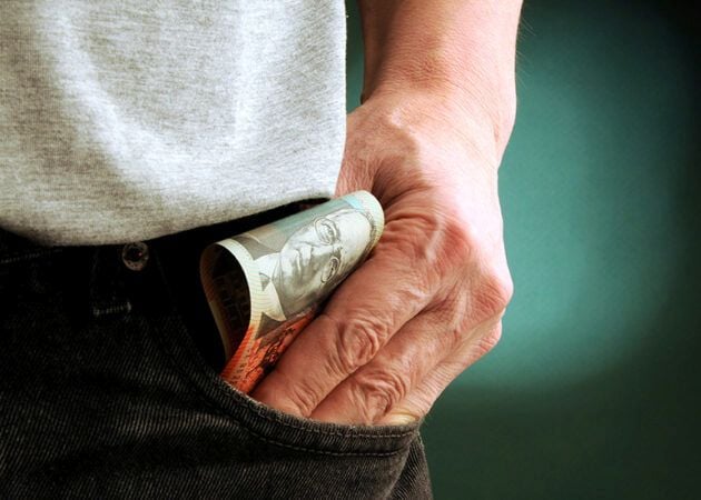 placing money in pocket