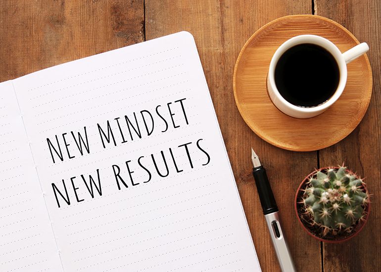 Notepad with the words 'new mindset, new results'