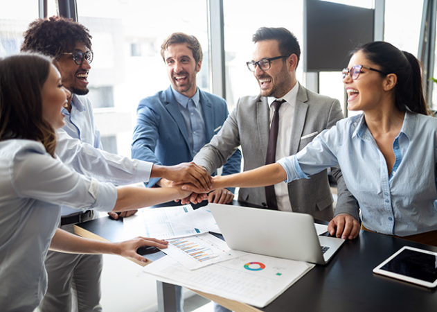 Office team joining hands in teamwork