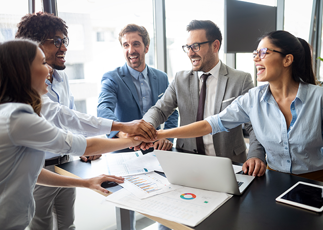 Office team joining hands in teamwork