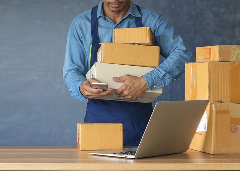 Man using smartphone to track mail packages