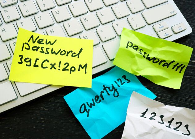 passwords written on post-it notes around keyboard