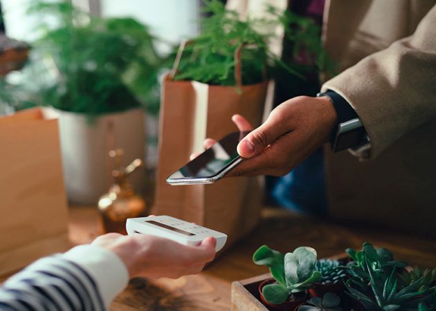 Customer using smartphone at checkout