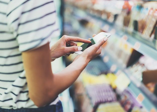 Woman using phone in store