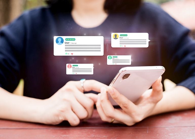 Woman checking phone for social media comments