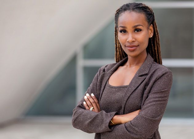 Confident business woman CEO in a suit with arms crossed