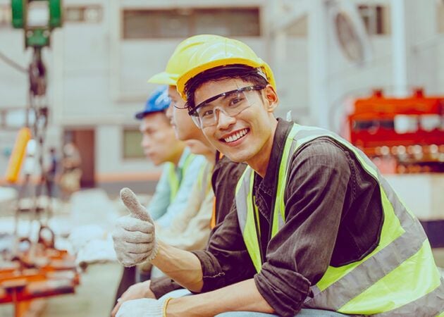 Happy young factory worker in training