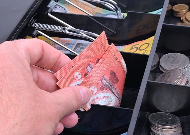 Taking $20 notes from cash register