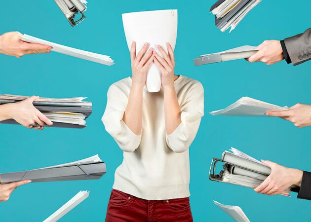 Overworked office worker hiding behind document