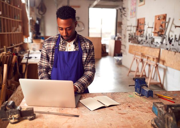 Tradie in workshop writing blog