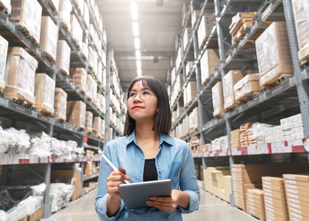 woman in warehouse with stocktake device