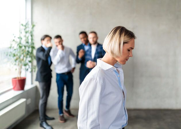 Woman feeling ostracised by bullying group at work