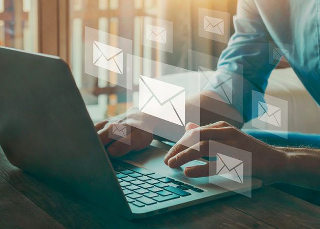 Person writing emails on laptop