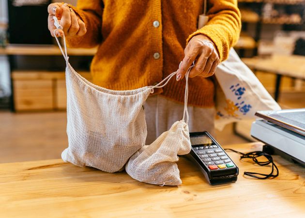 woman using net bags for shopping at checkout