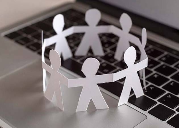 community of paper cut outs holding hands