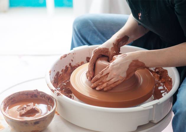 woman throwing a pot - an example of a creative business