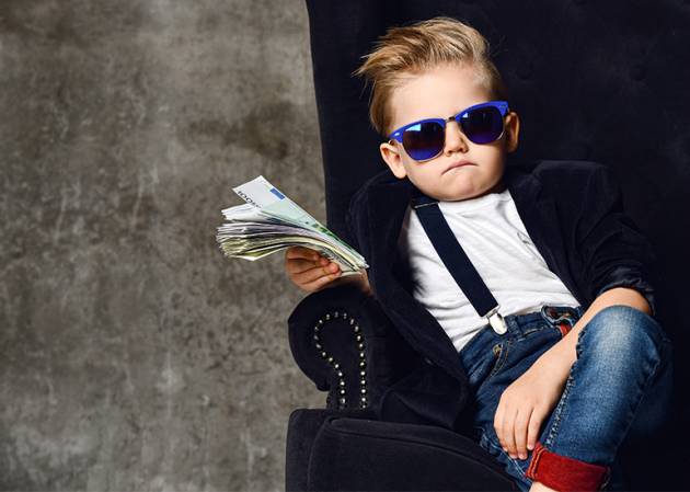 millionaire mindset - toddler in suit waving a wad of money