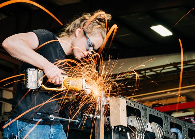 tradies - trades person using a grinder, sparks fly